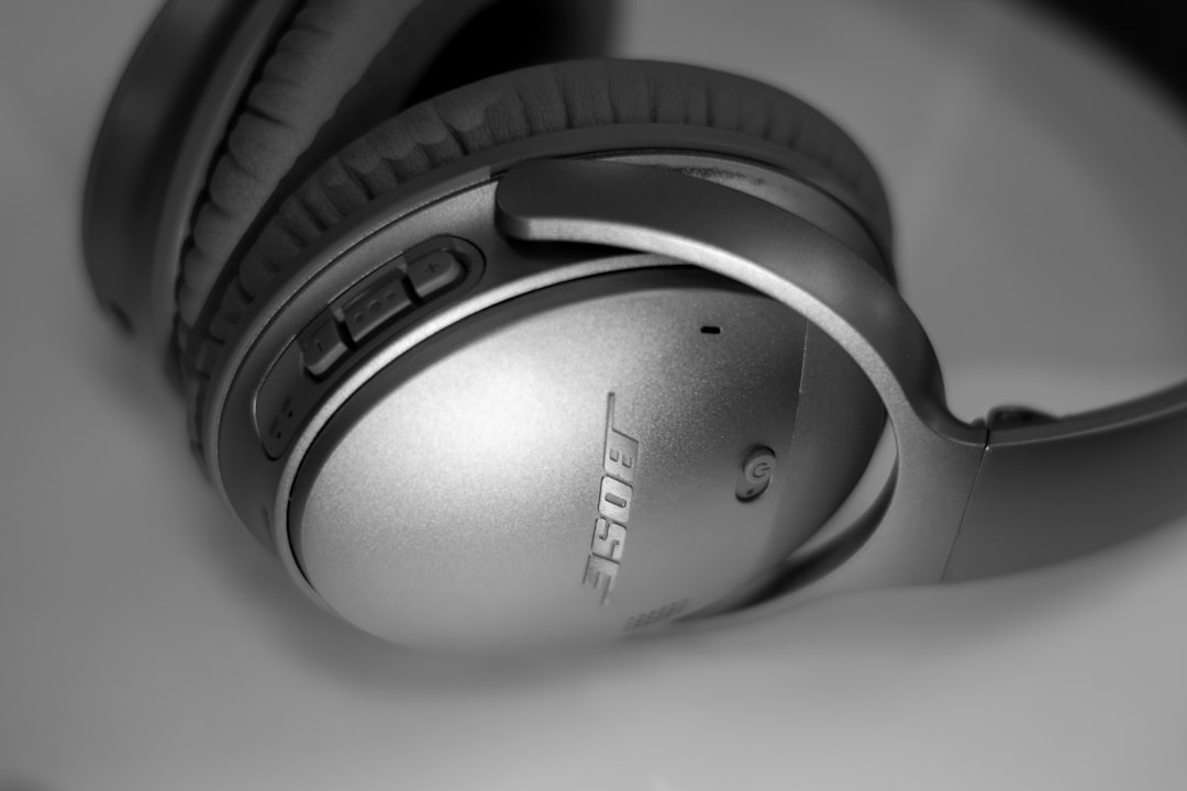 grey Bose wireless headphones, Silver Bose Bluetooth Headphones close-up on a white table