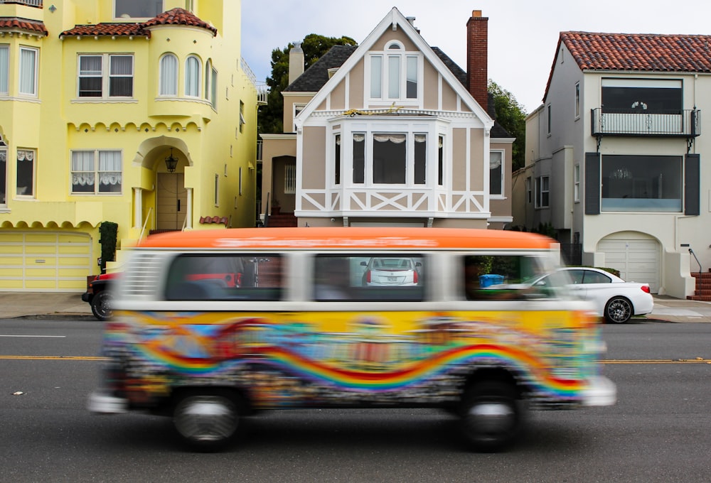 a bus driving down a street next to houses