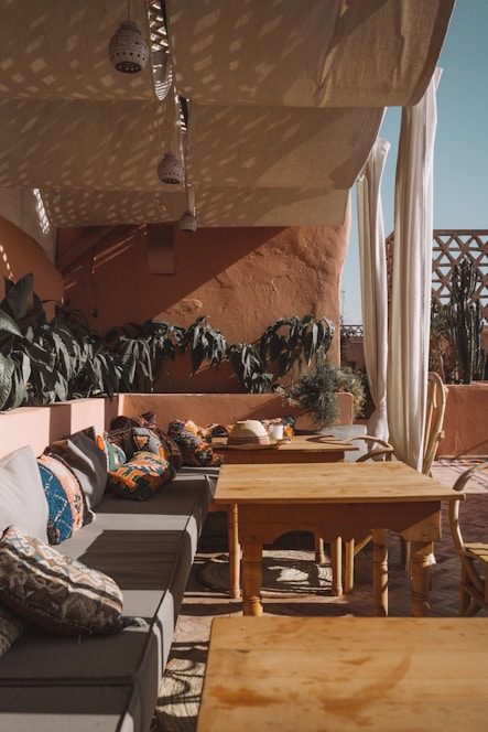 rectangular brown wooden table near gray couch with throw pillows