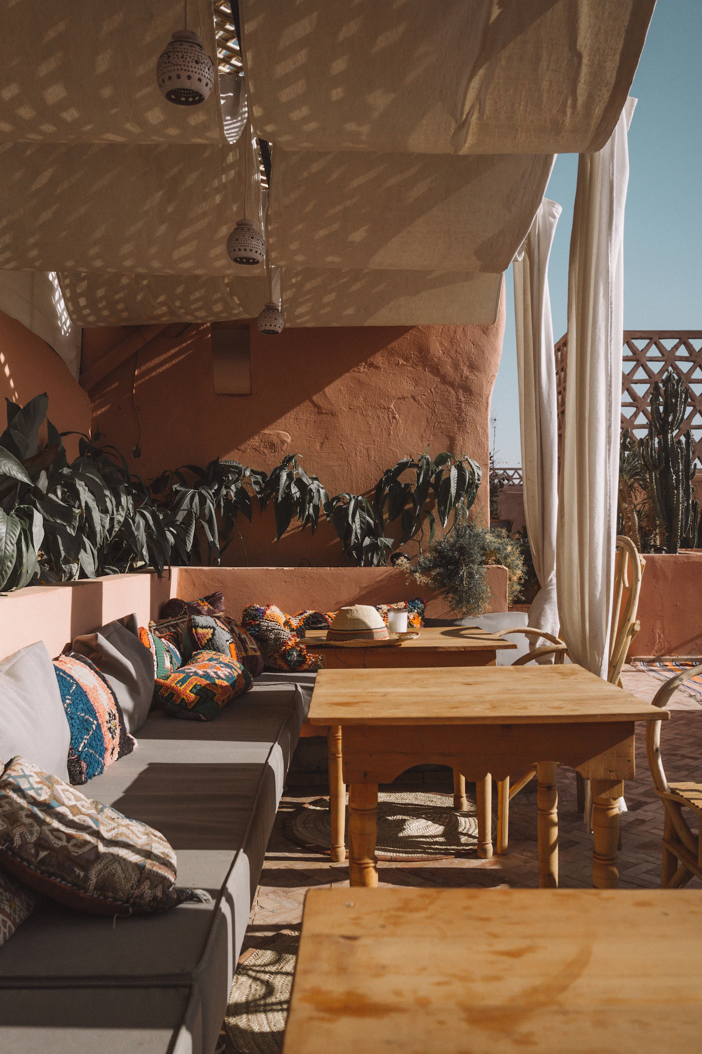 Toit-terrasse de riad marrakchi avec banquettes et tadelakt