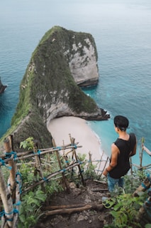 man standing near cliff in Nusa Penida in bali