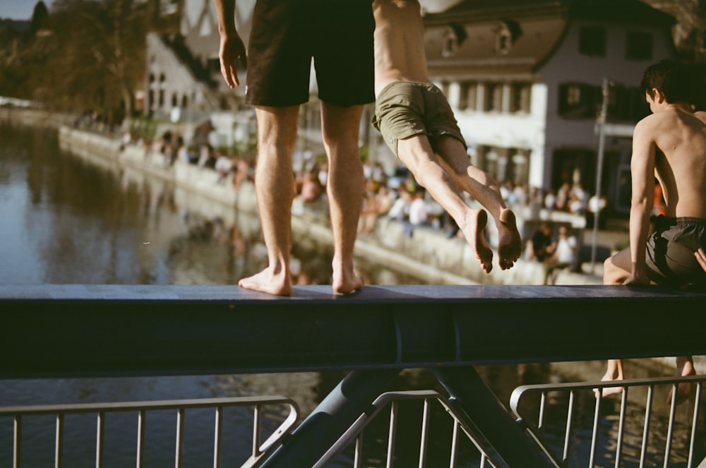 person jumping on bridge