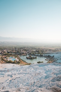 aerial photography of houses near body of water under blue and white sky during daytime