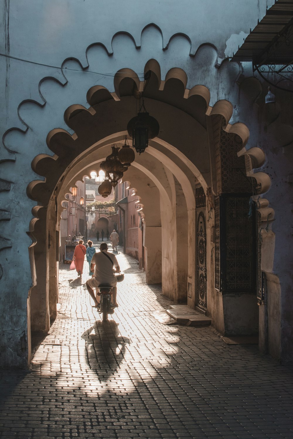man under tunnel on scooter during daytime in morocco