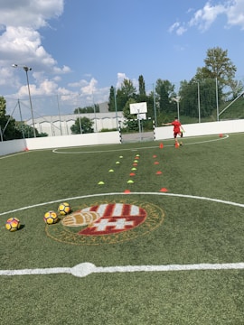 A young athlete practicing football skills on a training field.