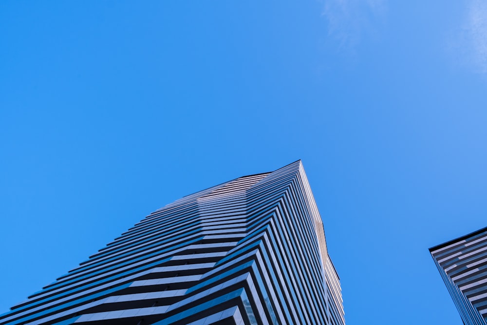 low-angle photography of blue high-rise building