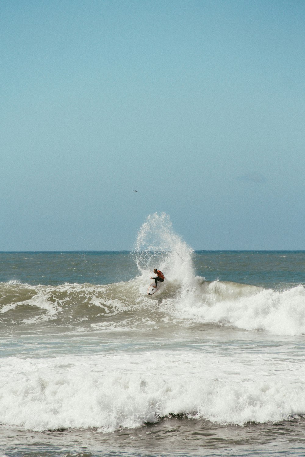 man playing surfboarding during daytime