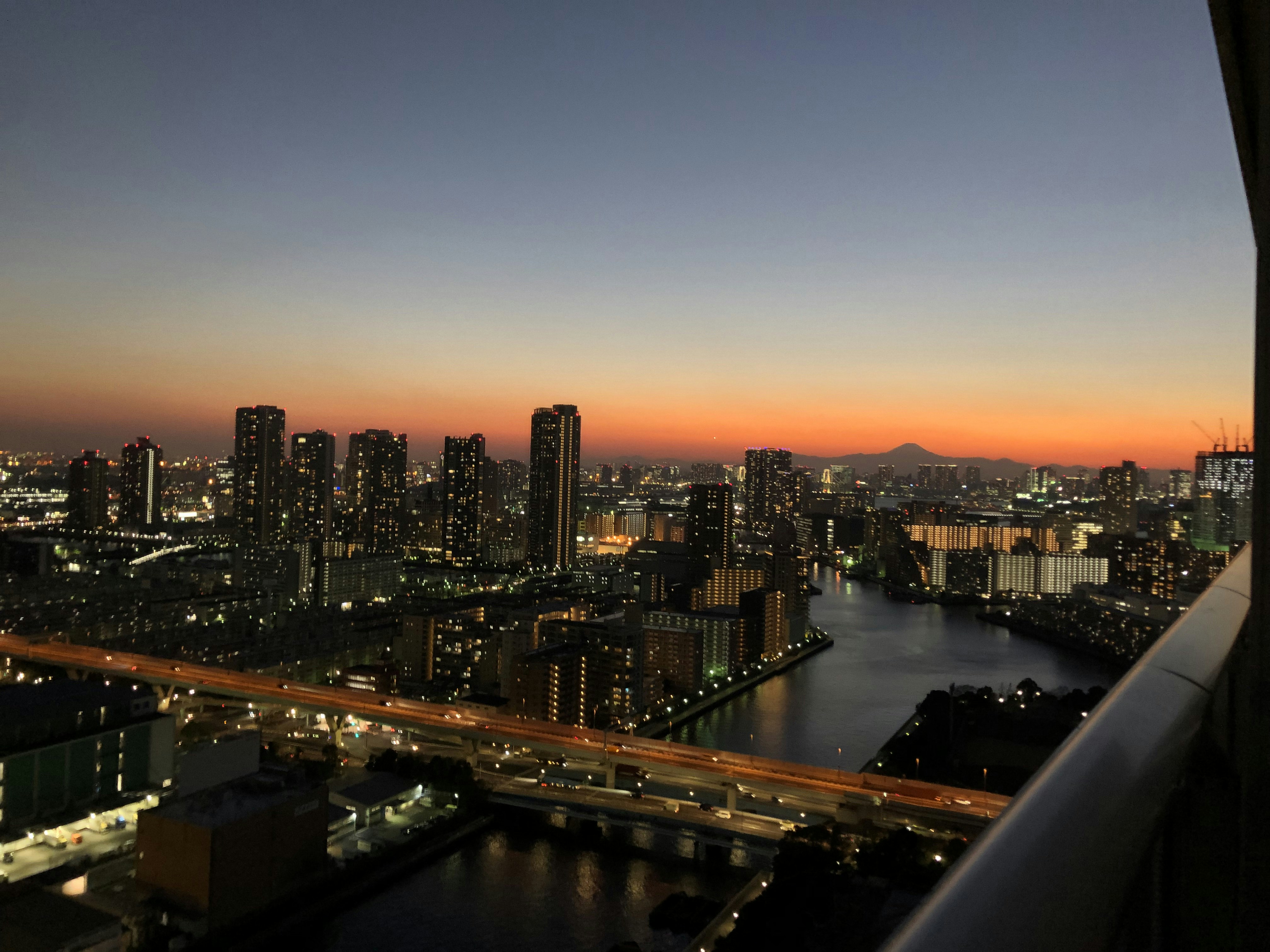 gray buildings near body of water during golden hour