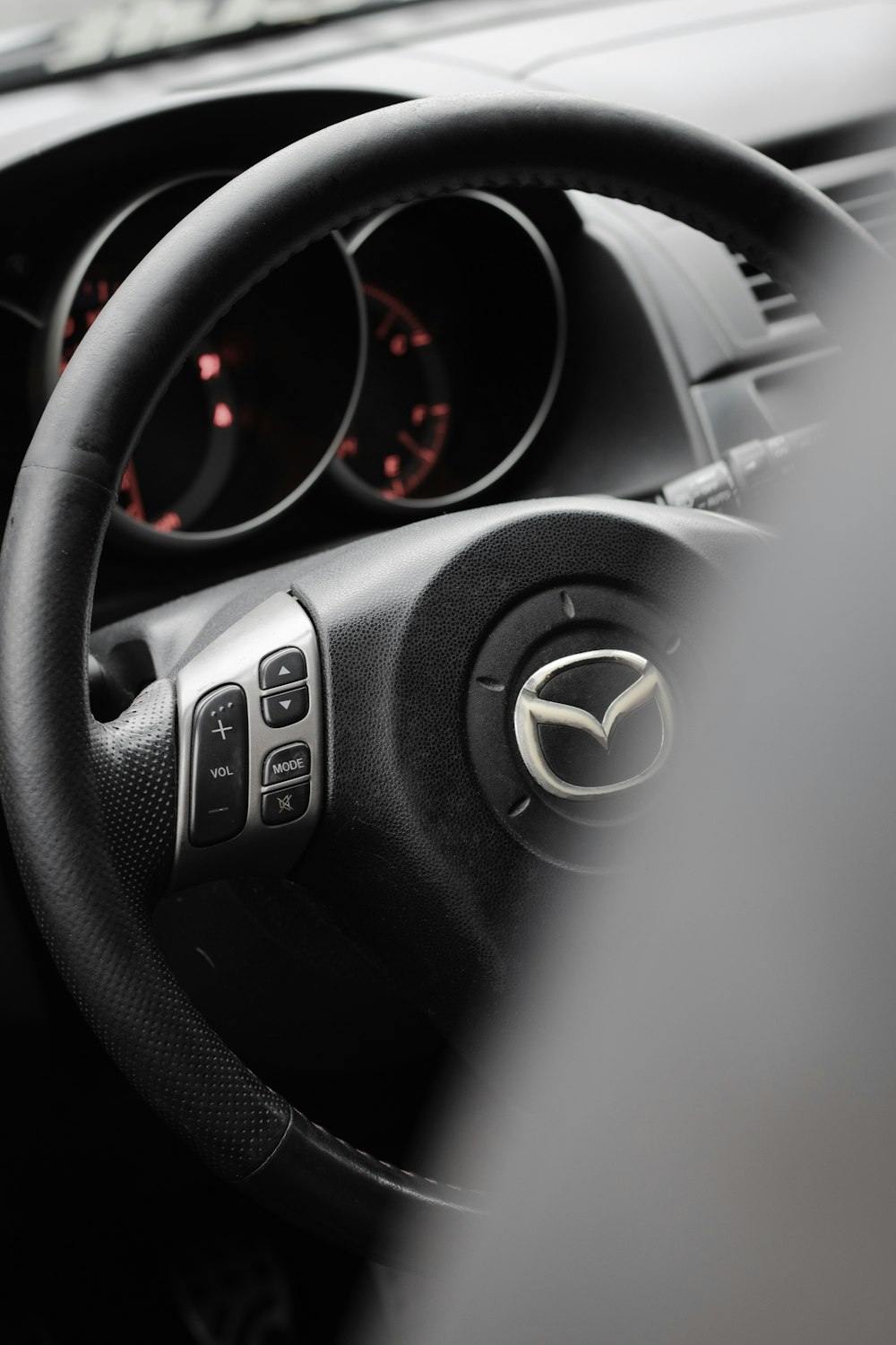 black Mazda vehicle steering wheel