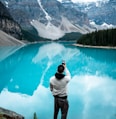 man standing on Moraine Lake during daytime