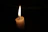 Close-up of a Flambeau candle flame flickering against a cream background.
