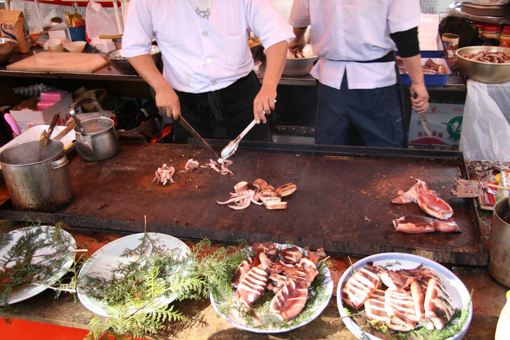 man slicing squids