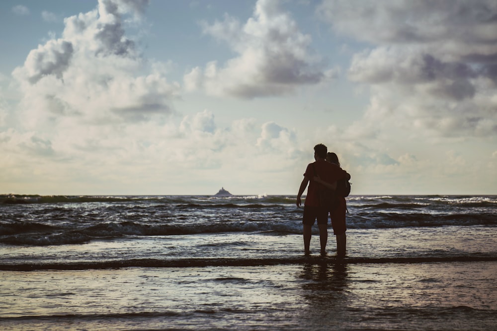 silhouette of person on seashore during daytime