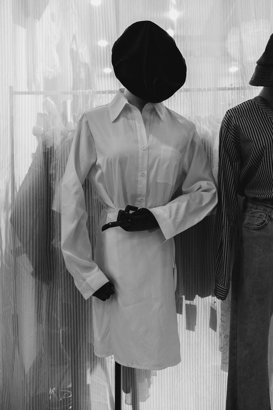 greyscale photography of long-sleeved dress on dress form
