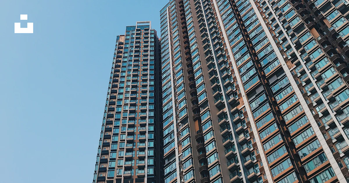 High Rise And Low Rise Building Low angle view of high-rise building photo – Free Blue Image on Unsplash