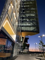 Evening view of a completed commercial complex illuminated with warm lights, reflecting Baran's quality.