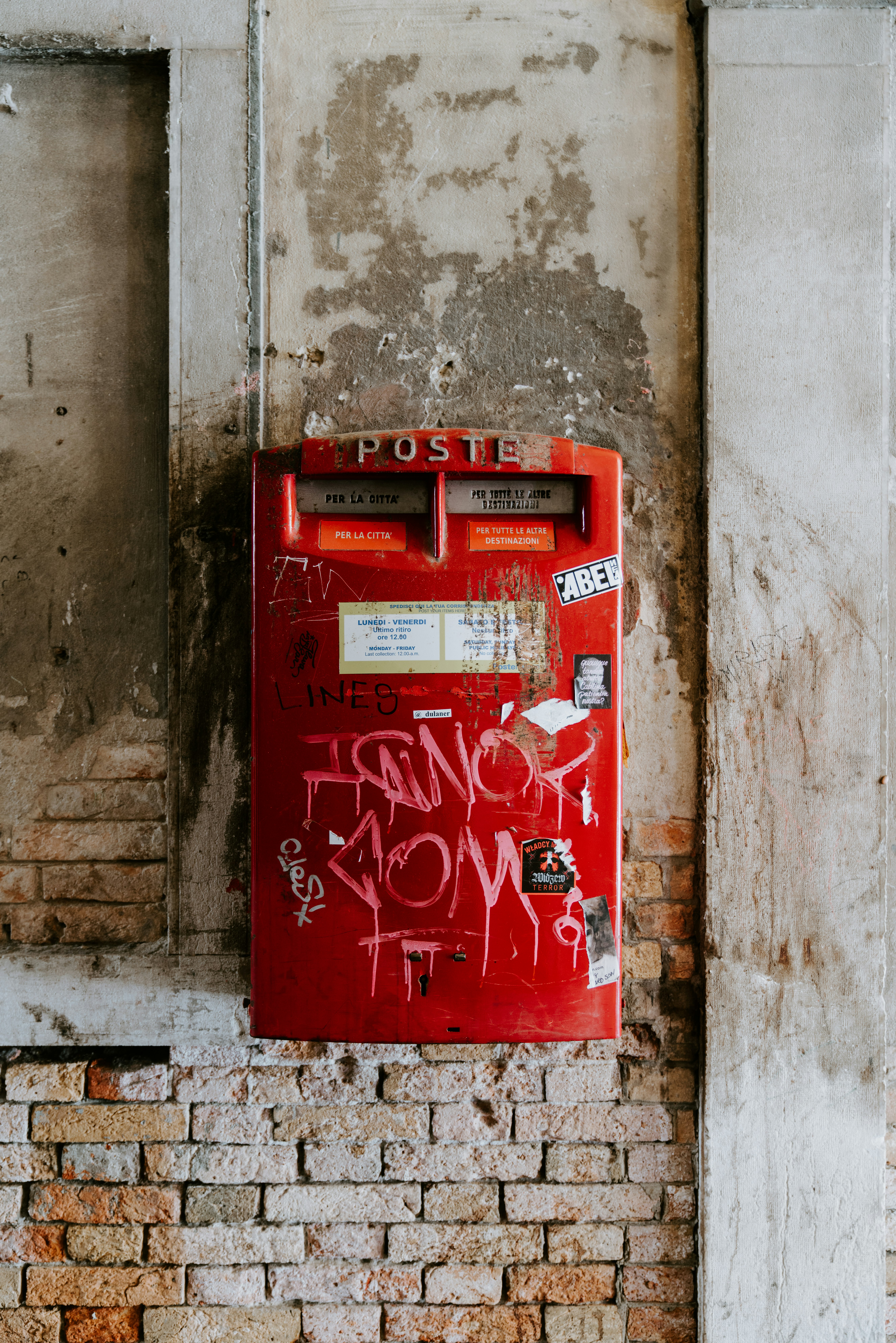 red Posto box on brick wall