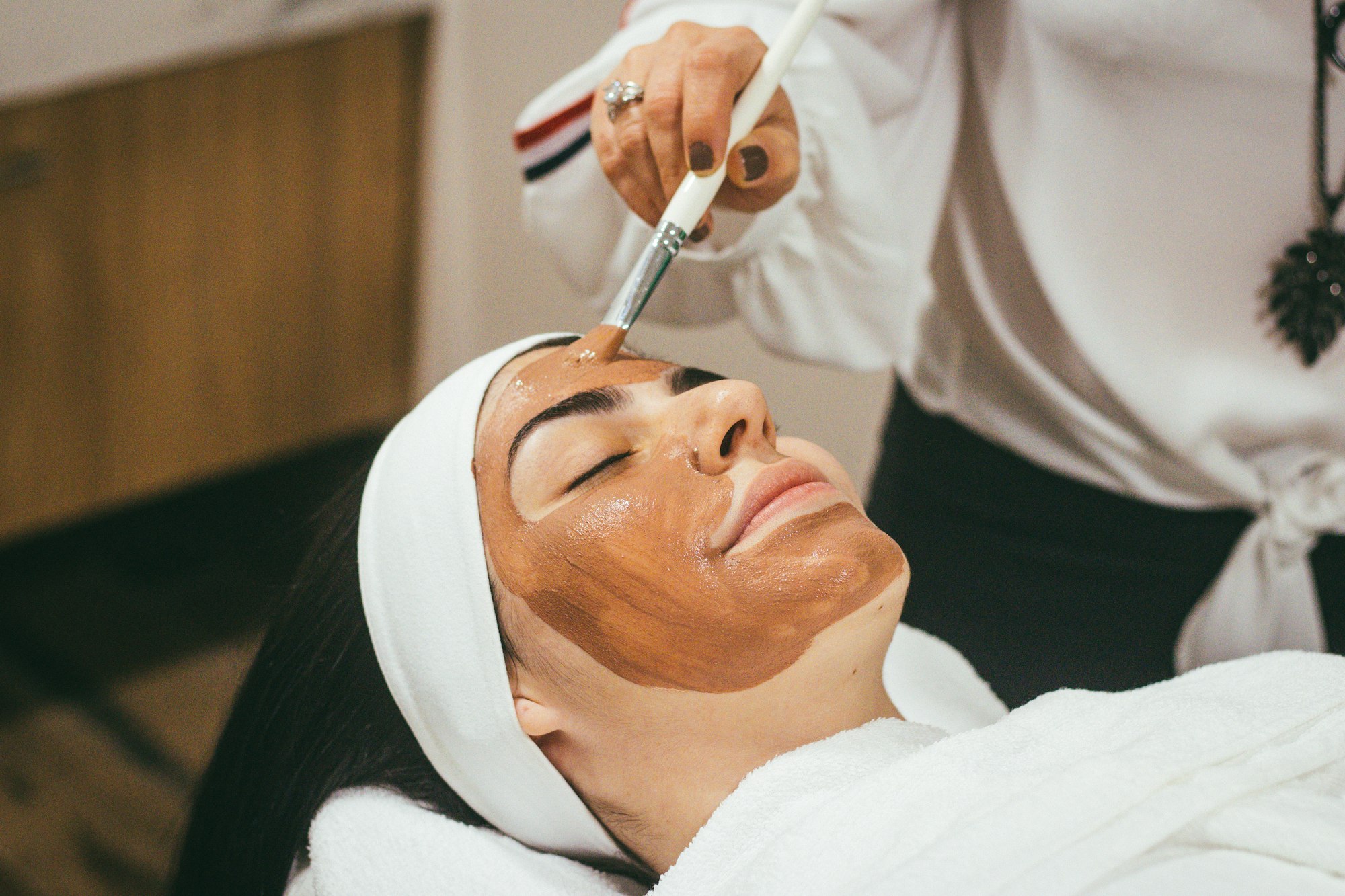 A woman receiving a facial care treatment