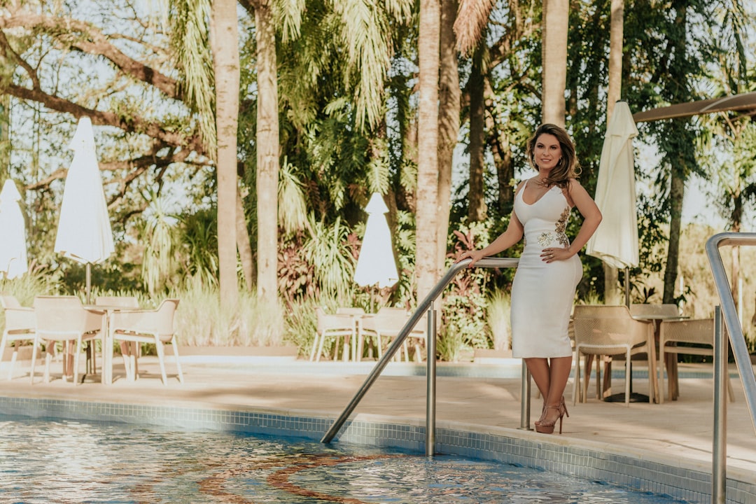 woman standing beside swimming pool