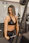 woman wearing black sport bra pulling bar