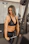 woman wearing black sport bra pulling bar