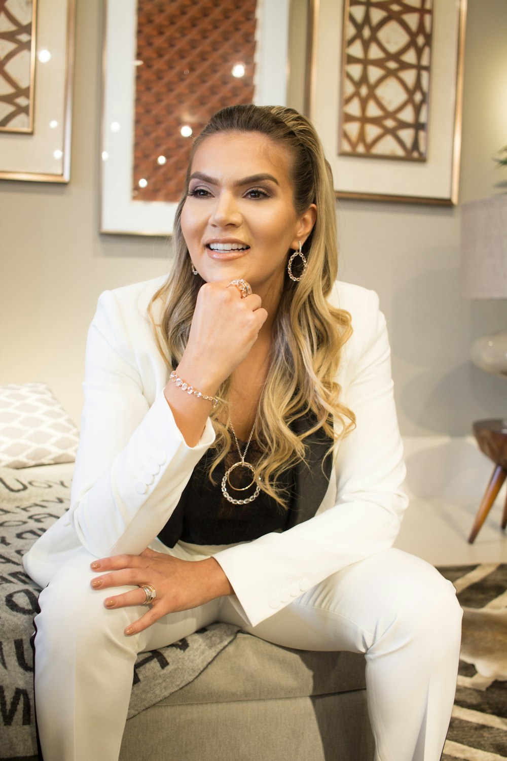 woman in white top sitting on sofa