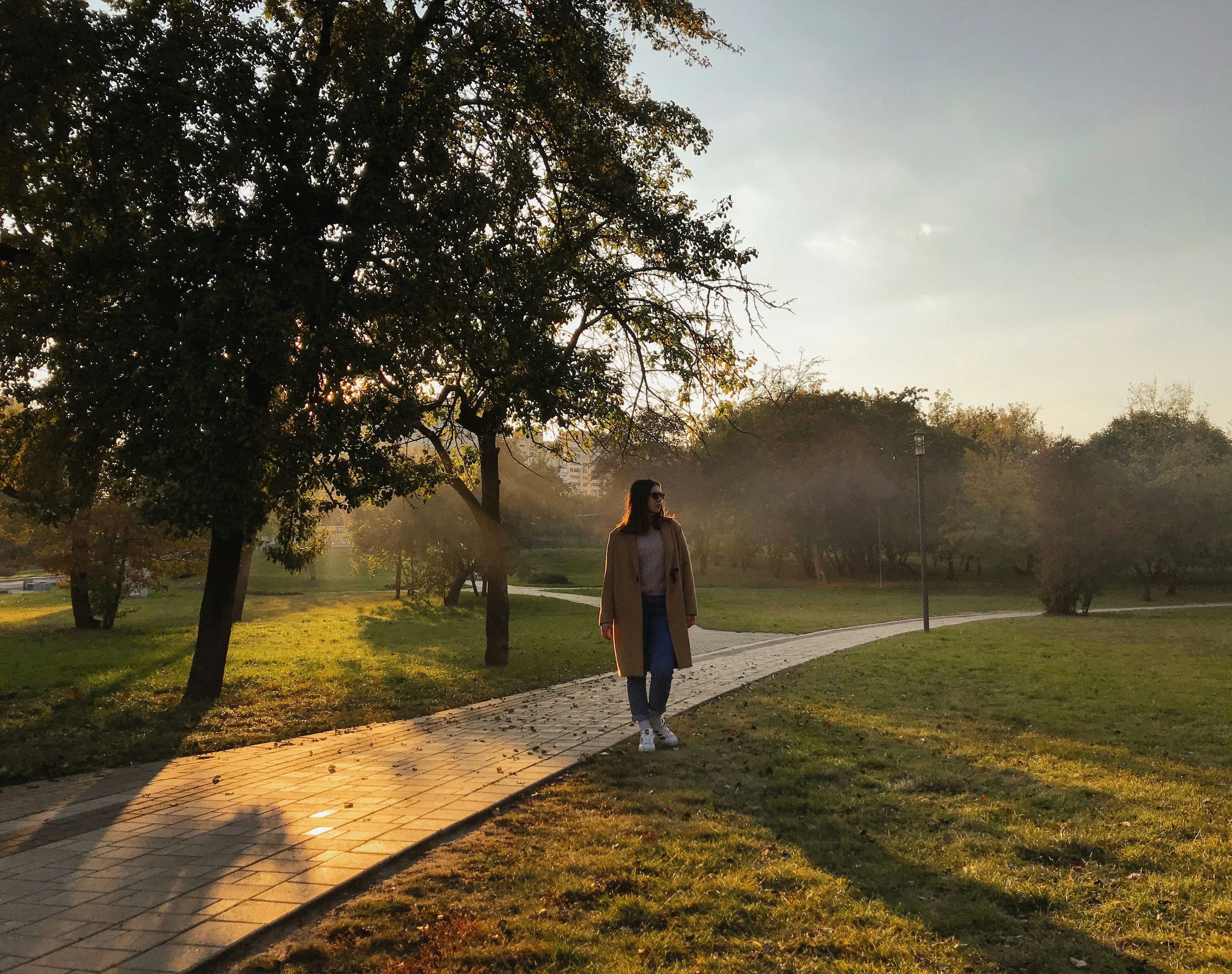 woman standing near pathway during daytime