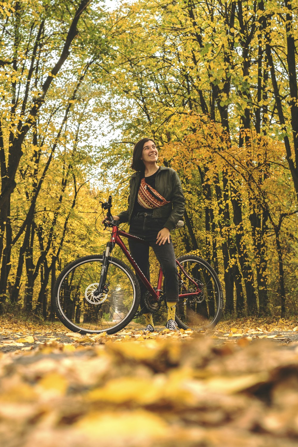 shallow focus photo of woman in black jacket riding hardtail bike