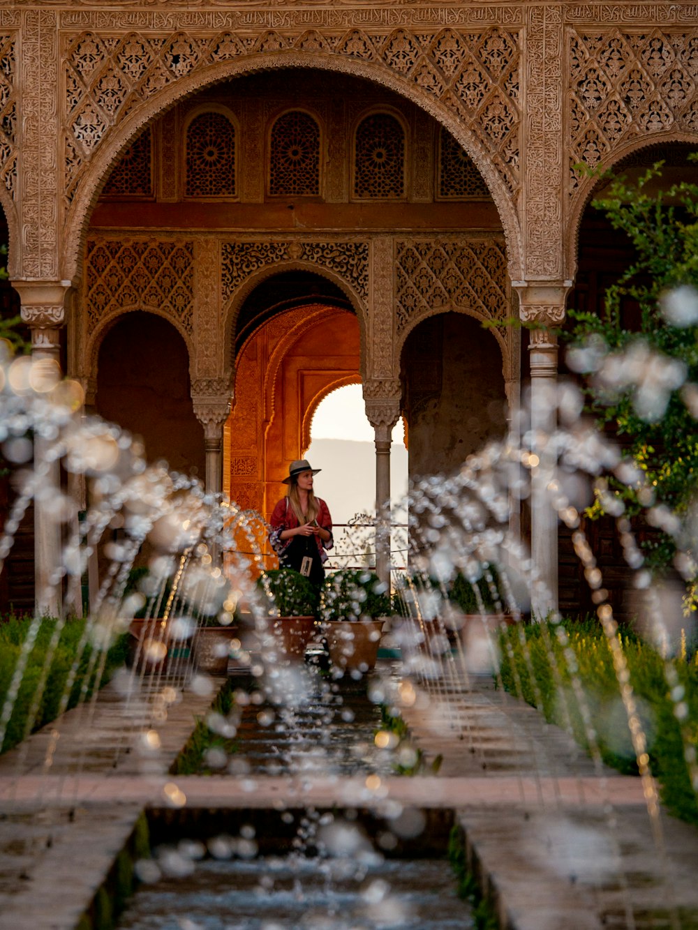 woman standing near fountain during daytime