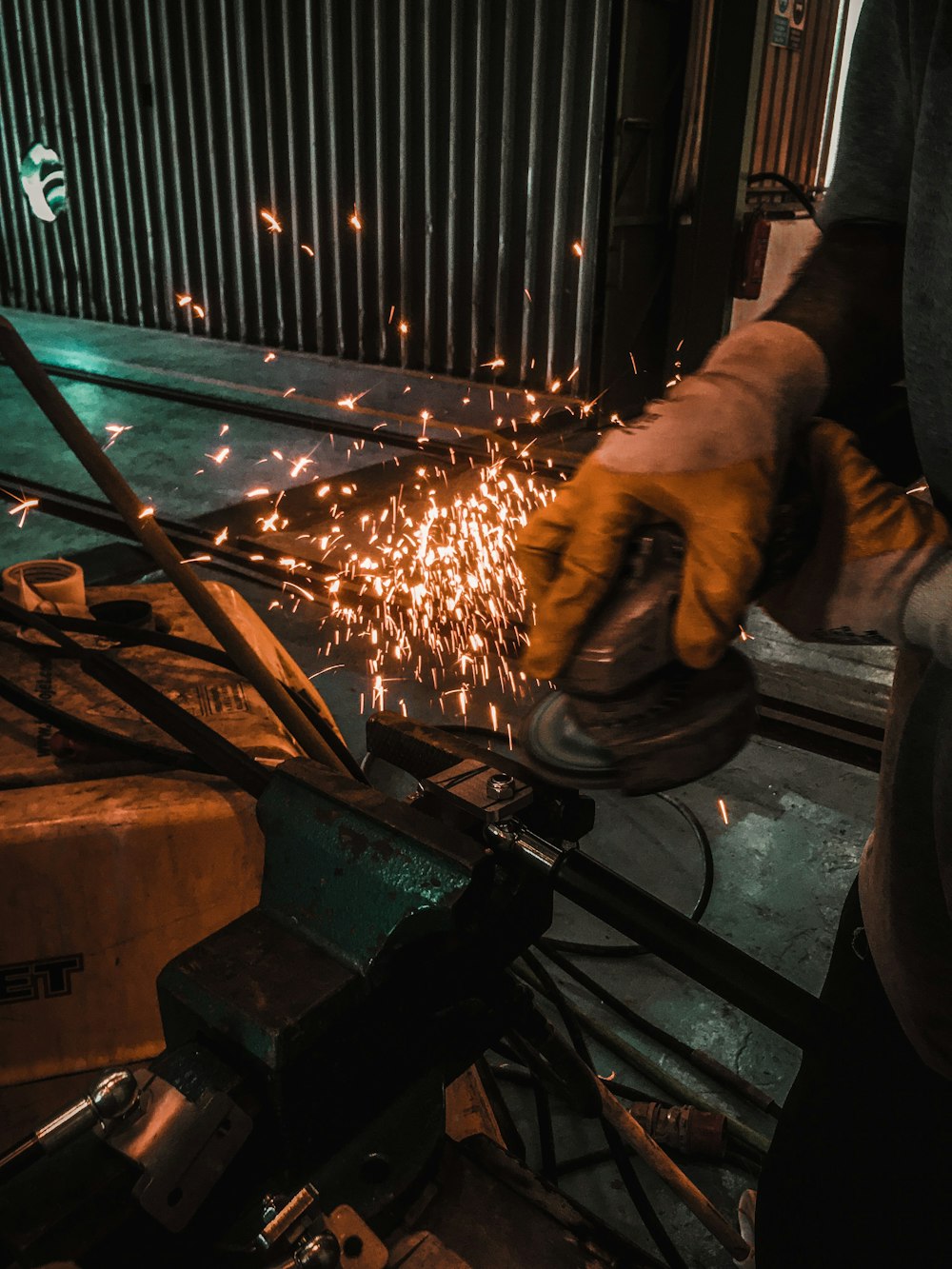 person grinding metal using angle grinder