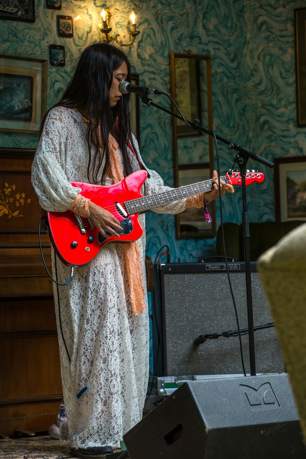 woman playing red guitar