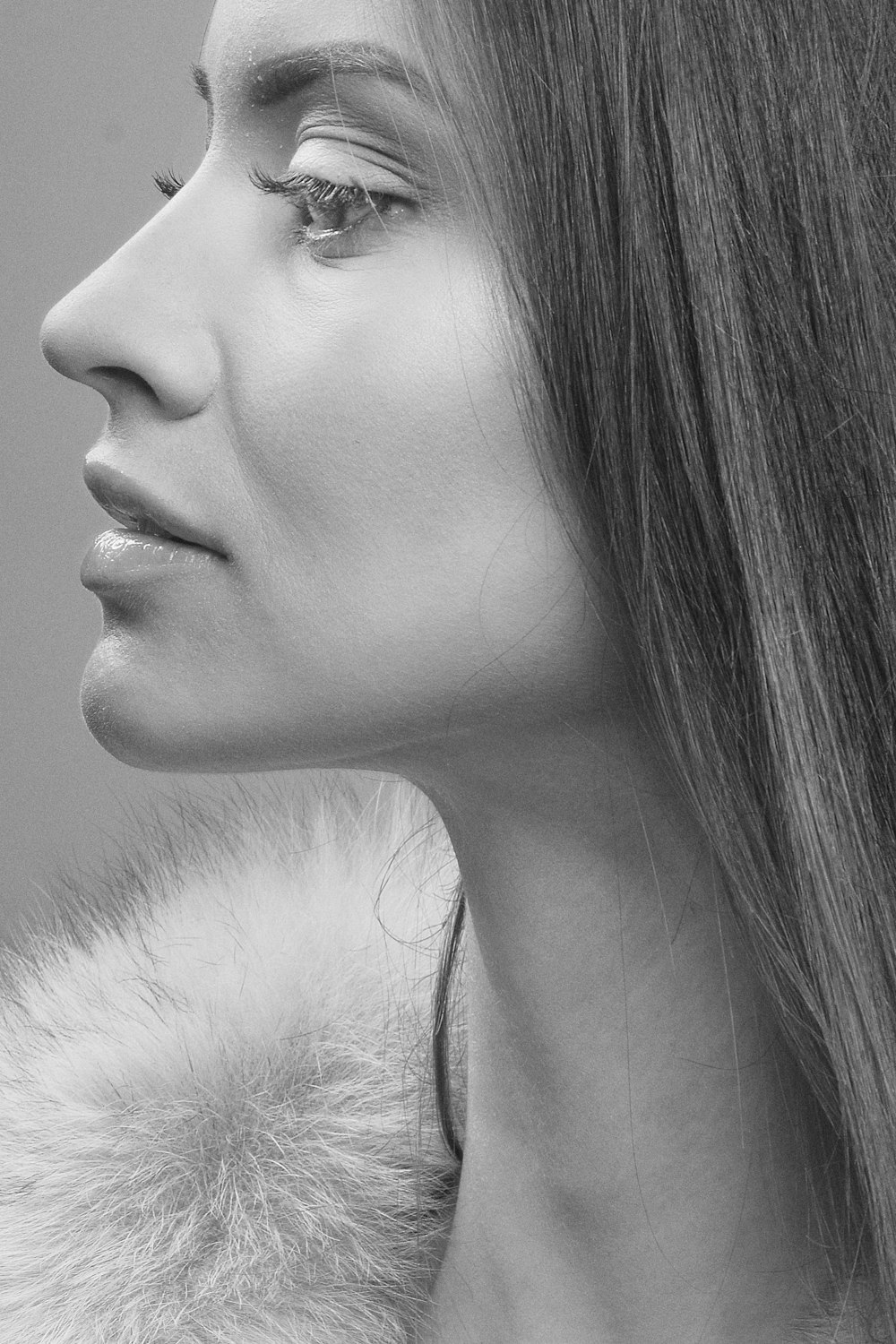 grayscale photo of woman in fur top