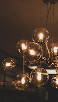 A cluster of elegant glass bulbs hanging at varying heights in a chic living room.