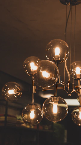 A cluster of elegant glass bulbs hanging at varying heights in a chic living room.