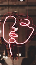 red woman's face neon light signage
