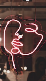 red woman's face neon light signage