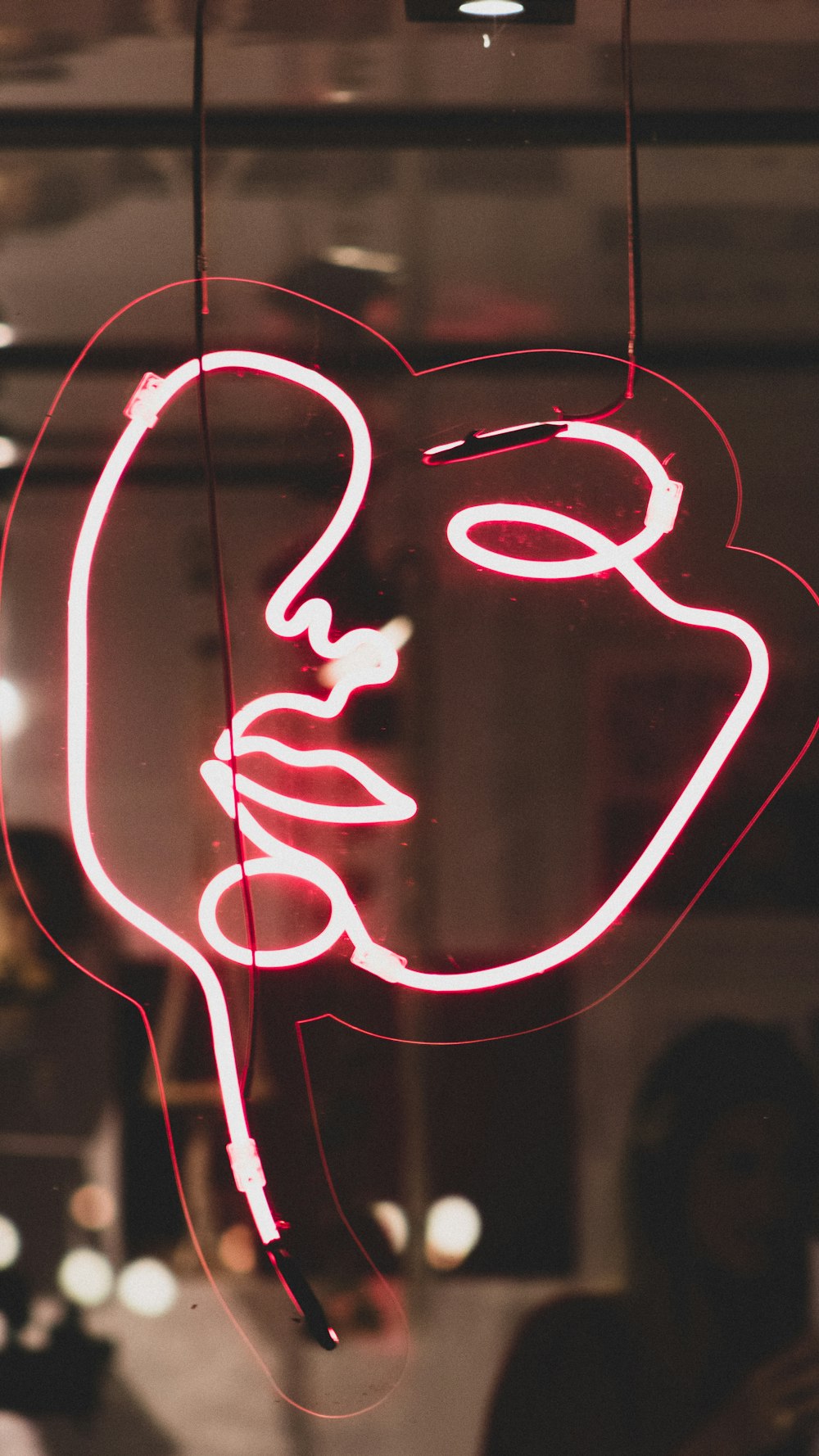 red woman's face neon light signage