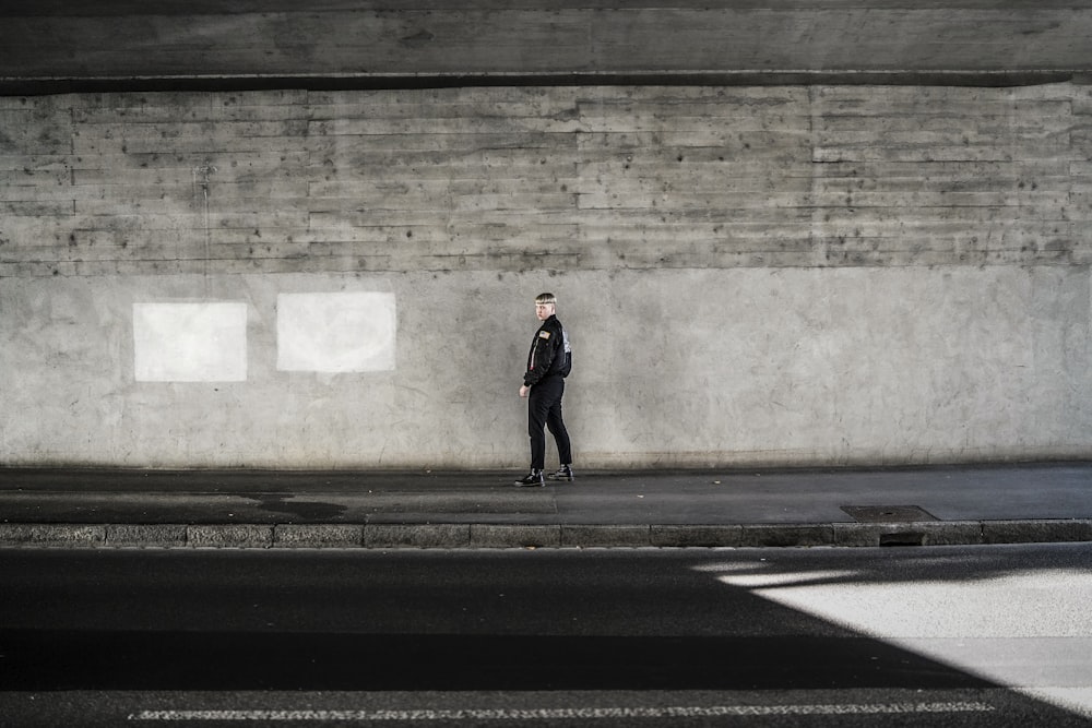 person stands on the sidewalk