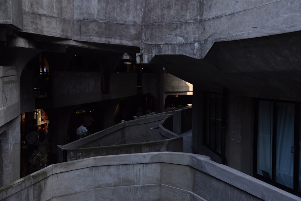 person walking inside building balcony