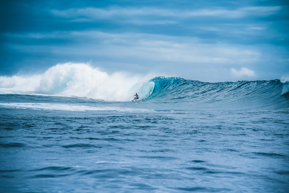 man surfing on sea waves during daytime