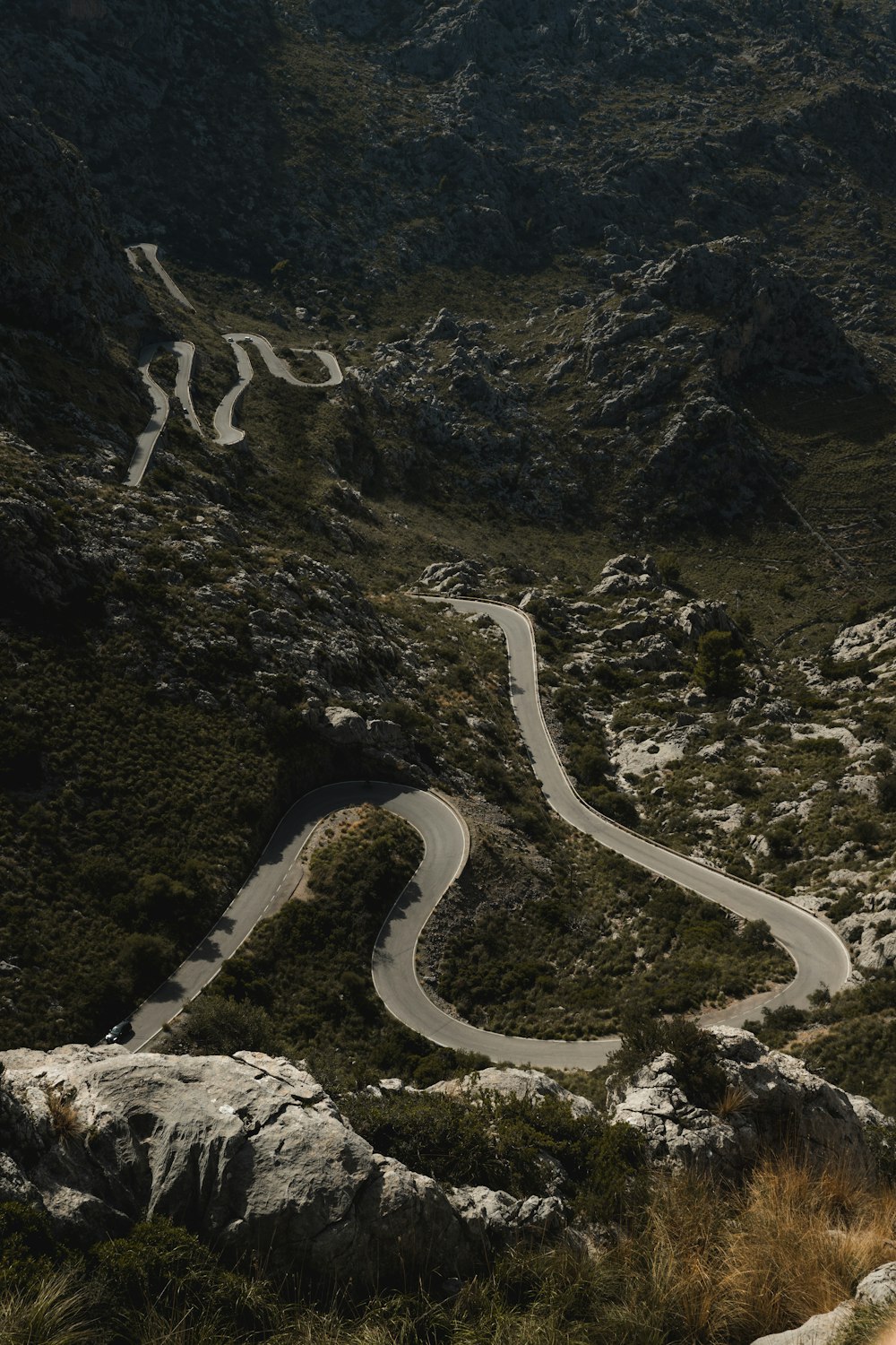 a winding road in the middle of a mountain