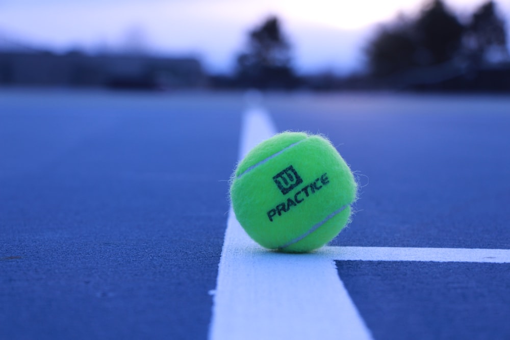 green Wilson practice tennis ball in field