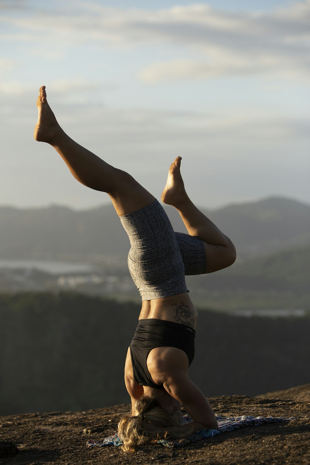 woman doing yoga on hill