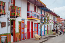 people walking on street beside white structure