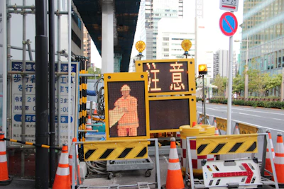 A panoramic view of a civil engineering project with neon blue safety cones and gold accents.