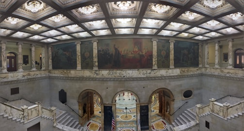 Wide shot of a commercial building lobby featuring decorative gypsum ceiling installations.