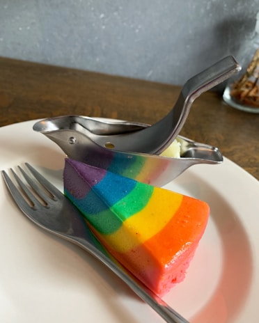 Vibrant jelly slices in a rainbow of colors displayed on a rustic wooden board.