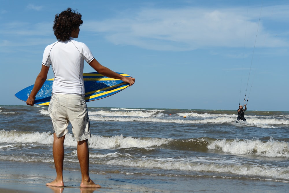 man holding surf board