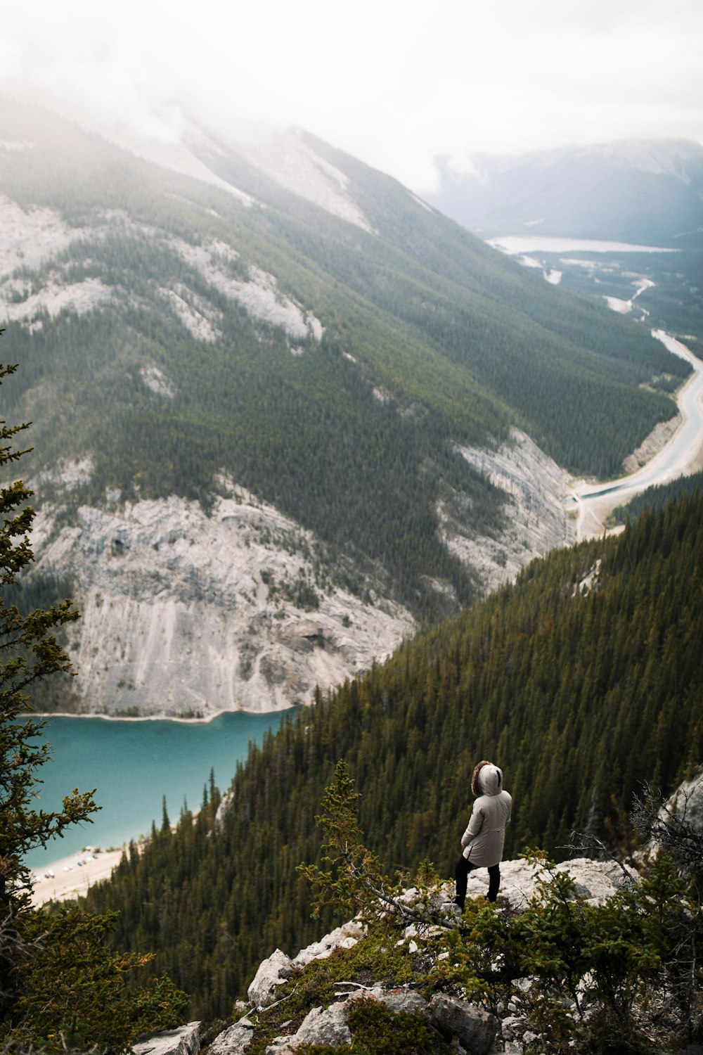 person standing on mountain cliff