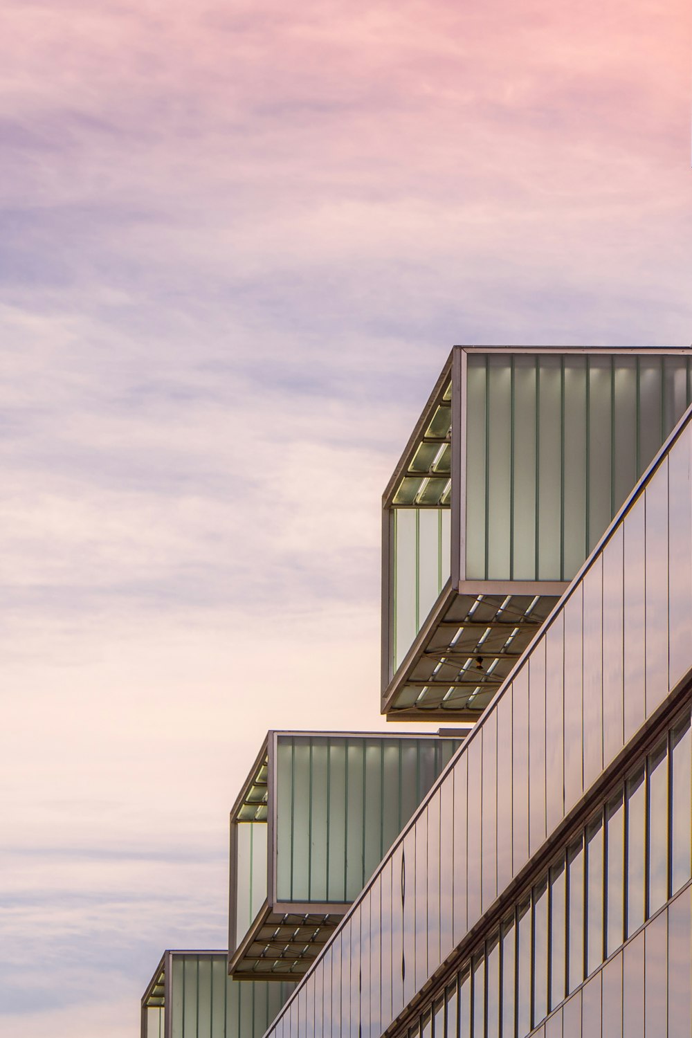 low-angle photography of a multi-storey building under a cloudy sky